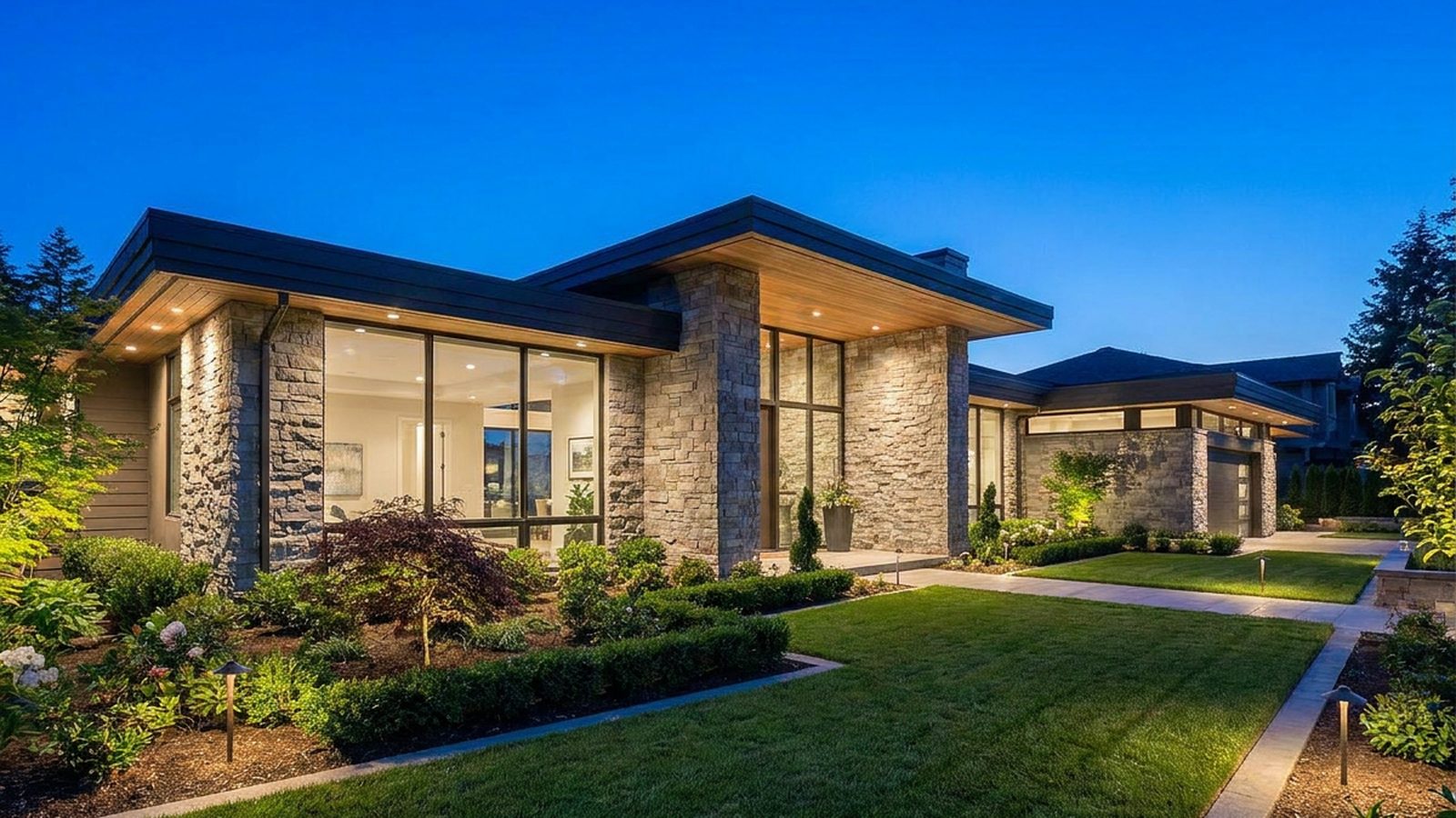 Stone and glass elevation lit at dusk